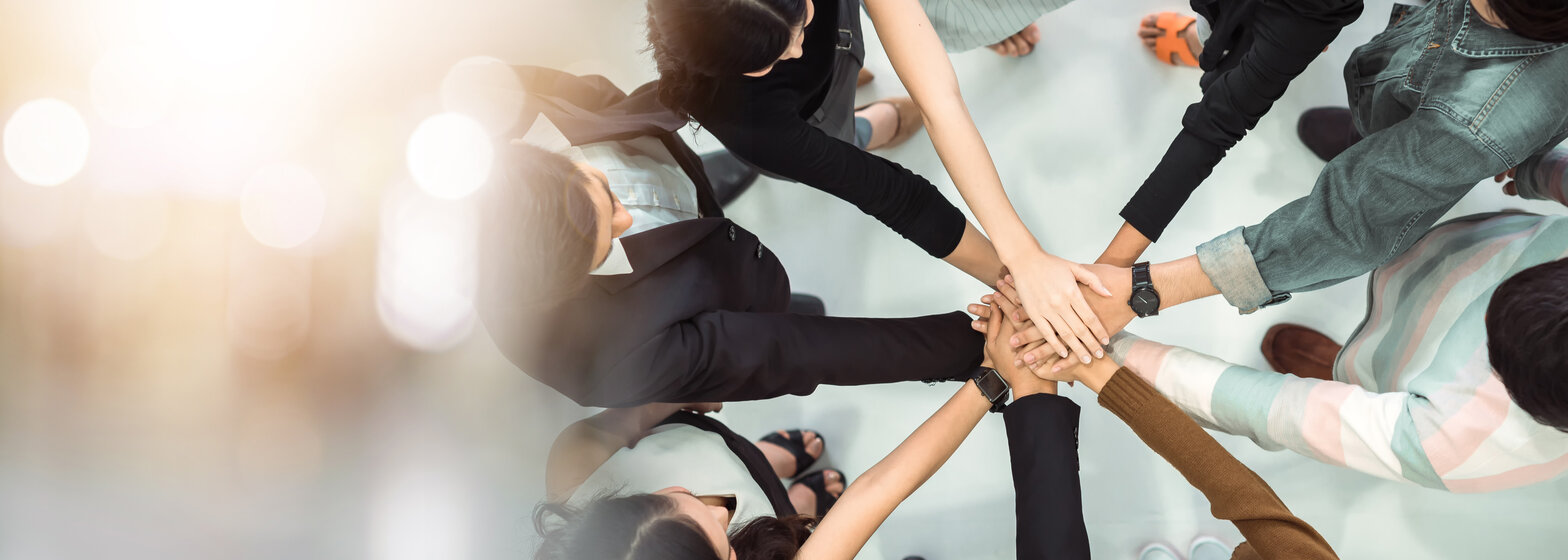 Hände eines Teams legen sich aufeinander als Symbol für Zusammenarbeit – Aktuelle Stellenangebote und Karrieremöglichkeiten bei MONTANA