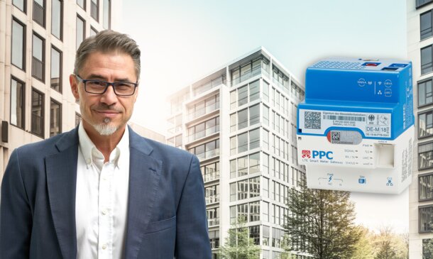 Experte vor einem Gebäudekomplex neben einem digitalen Smart Meter – Informationen zum Rollout intelligenter Zähler