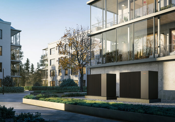 Moderne Wohnanlage mit installierten Wärmepumpen im Außenbereich – Nachhaltiges Heizen für Mehrparteienhäuse