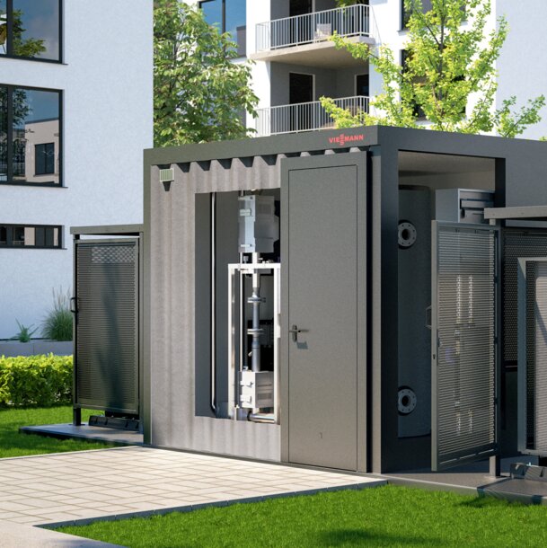 Moderne Heizzentrale in Container-Bauweise vor einer Wohnanlage – Haustechnik und Modernisierung für Immobilien